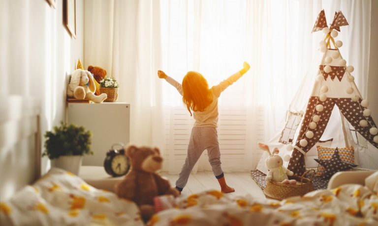 Children playing in a bright bedroom at home